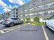 Exterior view of building with parking space marked by parking space #16 at 5980 80Th N St # 408, St Petersburg, FL 33709
