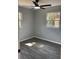 Bright bedroom featuring new flooring, fresh paint, and two windows at 14002 Morgan St, Dade City, FL 33525