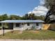 Charming single-story home with a new metal roof, a carport, and a freshly landscaped yard at 14002 Morgan St, Dade City, FL 33525