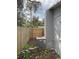 View of the side yard showing a new wooden fence and the home's AC unit at 14002 Morgan St, Dade City, FL 33525