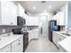 Well-lit kitchen features stainless steel appliances, modern cabinets, and tile backsplash at 2626 Scenic Park Loop, Wimauma, FL 33598