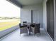 Enclosed outdoor patio with a view of a lake and seating area with table and 4 chairs at 2626 Scenic Park Loop, Wimauma, FL 33598