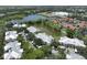 Aerial view of the residences, parking, landscaping, and tranquil lake at 3608 54Th W Dr # 202, Bradenton, FL 34210