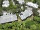Aerial view of the condo buildings, trees, well-maintained grounds, and asphalt roads at 3608 54Th W Dr # 202, Bradenton, FL 34210