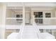 Condo porch with white railing, stairs, and lovely outdoor space at 3608 54Th W Dr # 202, Bradenton, FL 34210