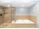Relaxing bathroom with a soaking tub, glass-enclosed shower, and neutral finishes at 3608 54Th W Dr # 202, Bradenton, FL 34210