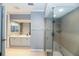 Bathroom featuring dual sinks, a frameless shower, and white tiling at 3608 54Th W Dr # 202, Bradenton, FL 34210