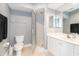 Bathroom with white cabinets, a toilet, and a walk-in shower behind a glass wall at 3608 54Th W Dr # 202, Bradenton, FL 34210