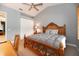 Bedroom with a wooden bed frame, desk, shutters, and a ceiling fan at 3608 54Th W Dr # 202, Bradenton, FL 34210