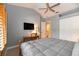 Bedroom features a desk, TV, and closet, bathed in natural light at 3608 54Th W Dr # 202, Bradenton, FL 34210