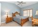 Bedroom has light blue walls, shutters, side tables, and a ceiling fan at 3608 54Th W Dr # 202, Bradenton, FL 34210