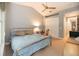 Inviting bedroom with a ceiling fan, plush bedding, and bright ambiance at 3608 54Th W Dr # 202, Bradenton, FL 34210