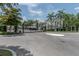 Gated entrance to the property with manicured landscaping, trees and well paved roads at 3608 54Th W Dr # 202, Bradenton, FL 34210