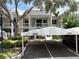 Exterior view of building and designated covered parking spots at 3608 54Th W Dr # 202, Bradenton, FL 34210