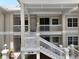 Exterior view of building with a staircase leading to the residences at 3608 54Th W Dr # 202, Bradenton, FL 34210