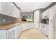 Well-lit kitchen featuring white cabinetry, tile flooring, and modern appliances at 3608 54Th W Dr # 202, Bradenton, FL 34210