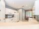 Bright kitchen with white cabinets, appliances, and a breakfast nook at 3608 54Th W Dr # 202, Bradenton, FL 34210
