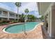 Outdoor pool featuring palm trees, lounge chairs, and well maintained grounds with brick pavers at 3608 54Th W Dr # 202, Bradenton, FL 34210