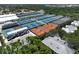 Aerial view showcasing numerous well-maintained tennis courts amidst lush greenery at 3608 54Th W Dr # 202, Bradenton, FL 34210
