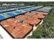 Aerial view highlighting the meticulously maintained tennis courts and the surrounding landscape at 3608 54Th W Dr # 202, Bradenton, FL 34210