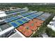 An aerial view showcasing an array of tennis courts within a vibrant, green landscape at 3608 54Th W Dr # 202, Bradenton, FL 34210