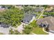 Aerial view of the home showcasing the backyard with a screened-in pool and mature landscaping at 3911 Smoke Rise Ct, Valrico, FL 33594