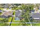 Aerial view showcasing the backyard pool, privacy fence, and mature trees at 3911 Smoke Rise Ct, Valrico, FL 33594