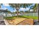 Large backyard featuring mature trees, a stone patio, and a well-maintained lawn at 3911 Smoke Rise Ct, Valrico, FL 33594