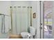 This bathroom features a toilet and shower combo and a door leading to the pool area at 3911 Smoke Rise Ct, Valrico, FL 33594