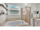 Relaxing bathroom with a soaking tub and glass-enclosed shower at 3911 Smoke Rise Ct, Valrico, FL 33594