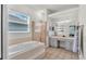 Well-lit bathroom featuring a separate tub and shower at 3911 Smoke Rise Ct, Valrico, FL 33594