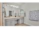 Spacious bathroom featuring dual sinks, mirrors, and white cabinetry at 3911 Smoke Rise Ct, Valrico, FL 33594