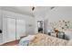 A comfortable bedroom with hardwood floors, and a desk with a wall of eclectic decorations at 3911 Smoke Rise Ct, Valrico, FL 33594