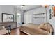 A lovely bedroom with hardwood floors, a comfortable bed and a dresser and desk with an antique mirror at 3911 Smoke Rise Ct, Valrico, FL 33594