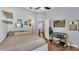 A spacious bedroom with hardwood floors, a comfortable bed, and a desk with a wooden chair at 3911 Smoke Rise Ct, Valrico, FL 33594