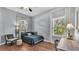 A serene bedroom featuring a comfortable bed, a desk area, and views to the backyard at 3911 Smoke Rise Ct, Valrico, FL 33594