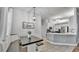 Dining area with shiplap accent wall and stylish light fixture adjacent to the modern kitchen at 3911 Smoke Rise Ct, Valrico, FL 33594
