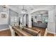Dining room featuring hardwood floors, modern lighting, and a view of the living room at 3911 Smoke Rise Ct, Valrico, FL 33594