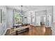 Dining room featuring hardwood floors, modern lighting, and a view of the front yard at 3911 Smoke Rise Ct, Valrico, FL 33594