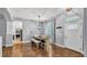 Dining room featuring hardwood floors, modern lighting, and a view of the front yard at 3911 Smoke Rise Ct, Valrico, FL 33594