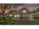Charming two-story home with a three-car garage, well-manicured lawn and attractive curb appeal at 3911 Smoke Rise Ct, Valrico, FL 33594