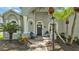 Comfortable front porch with chairs and inviting entry at 3911 Smoke Rise Ct, Valrico, FL 33594