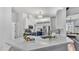 Modern kitchen with white cabinets, navy blue lower cabinets, stainless steel appliances, and quartz countertops at 3911 Smoke Rise Ct, Valrico, FL 33594
