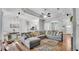Spacious open concept living room features a large sofa, hardwood floors, and abundant natural light at 3911 Smoke Rise Ct, Valrico, FL 33594