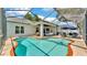 This kidney-shaped pool is surrounded by ample seating and a screened-in enclosure at 3911 Smoke Rise Ct, Valrico, FL 33594