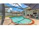 This beautiful screened-in pool is surrounded by comfortable seating and a dining area at 3911 Smoke Rise Ct, Valrico, FL 33594