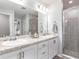 Bathroom with double sinks, granite countertops, and a glass enclosed shower at 6926 161St E Ter, Parrish, FL 34219