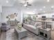 Bright and airy living room open to the kitchen, featuring neutral decor, stylish furniture, and a ceiling fan at 6926 161St E Ter, Parrish, FL 34219