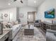 Well-lit living room featuring a comfortable seating arrangement, stylish decor, and an open floor plan at 6926 161St E Ter, Parrish, FL 34219