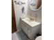 Bathroom showing sink with cabinets, and white tiled walls at 704 Queens Ct, Seffner, FL 33584